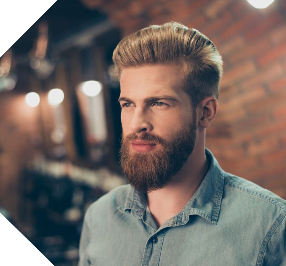 A man with a beard and mustache wearing a blue shirt